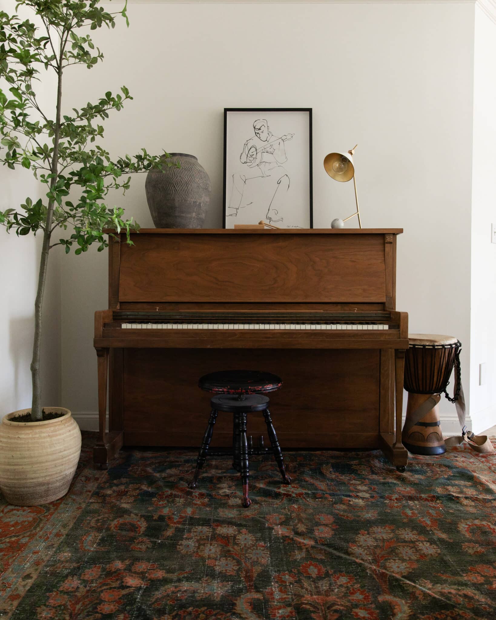 Chris Loves Julia | Upstairs landing with piano, stool and brass lamp