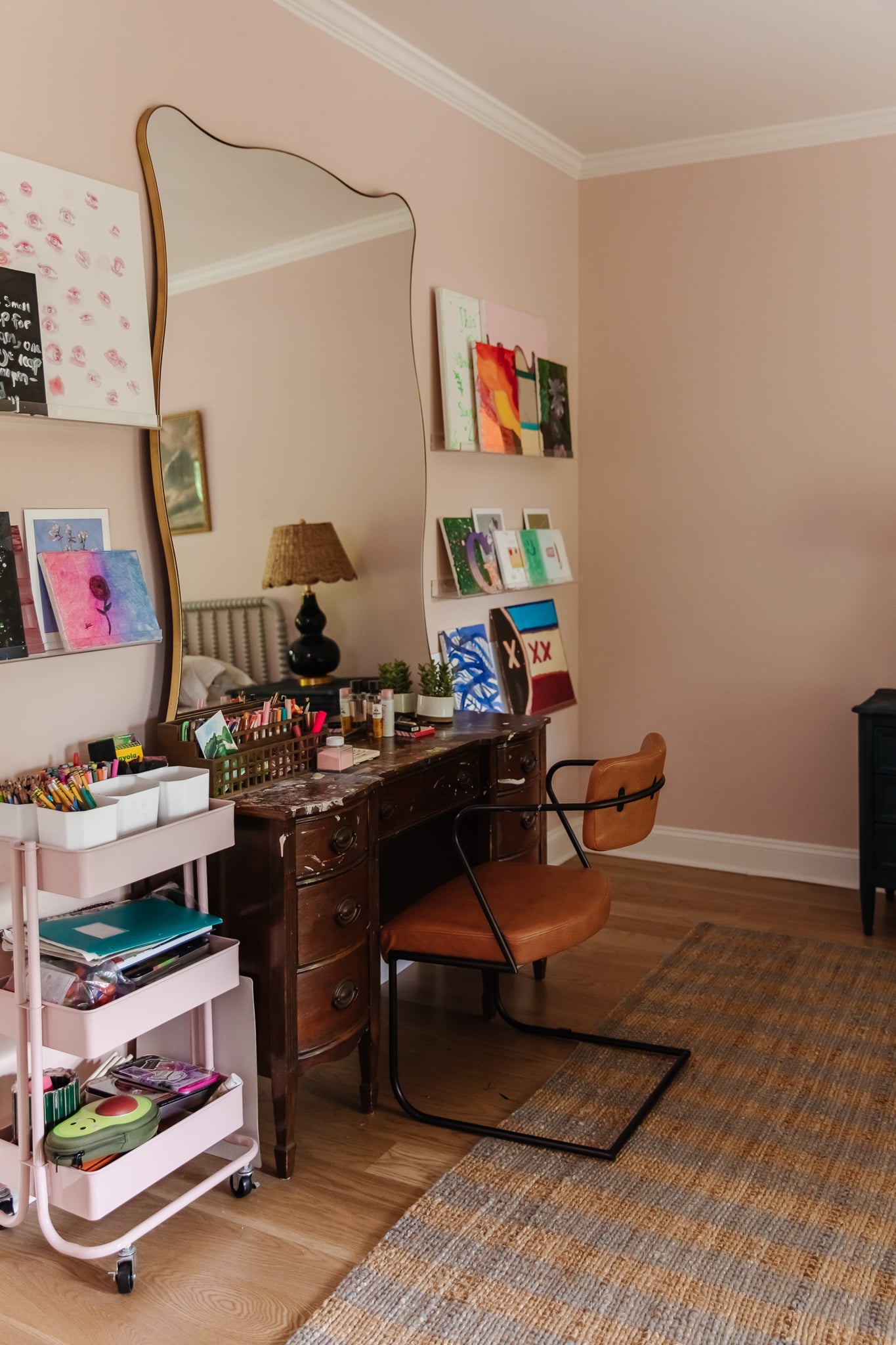 Chris Loves Julia | Greta's bedroom with pale pink paint and art desk with oversized mirror