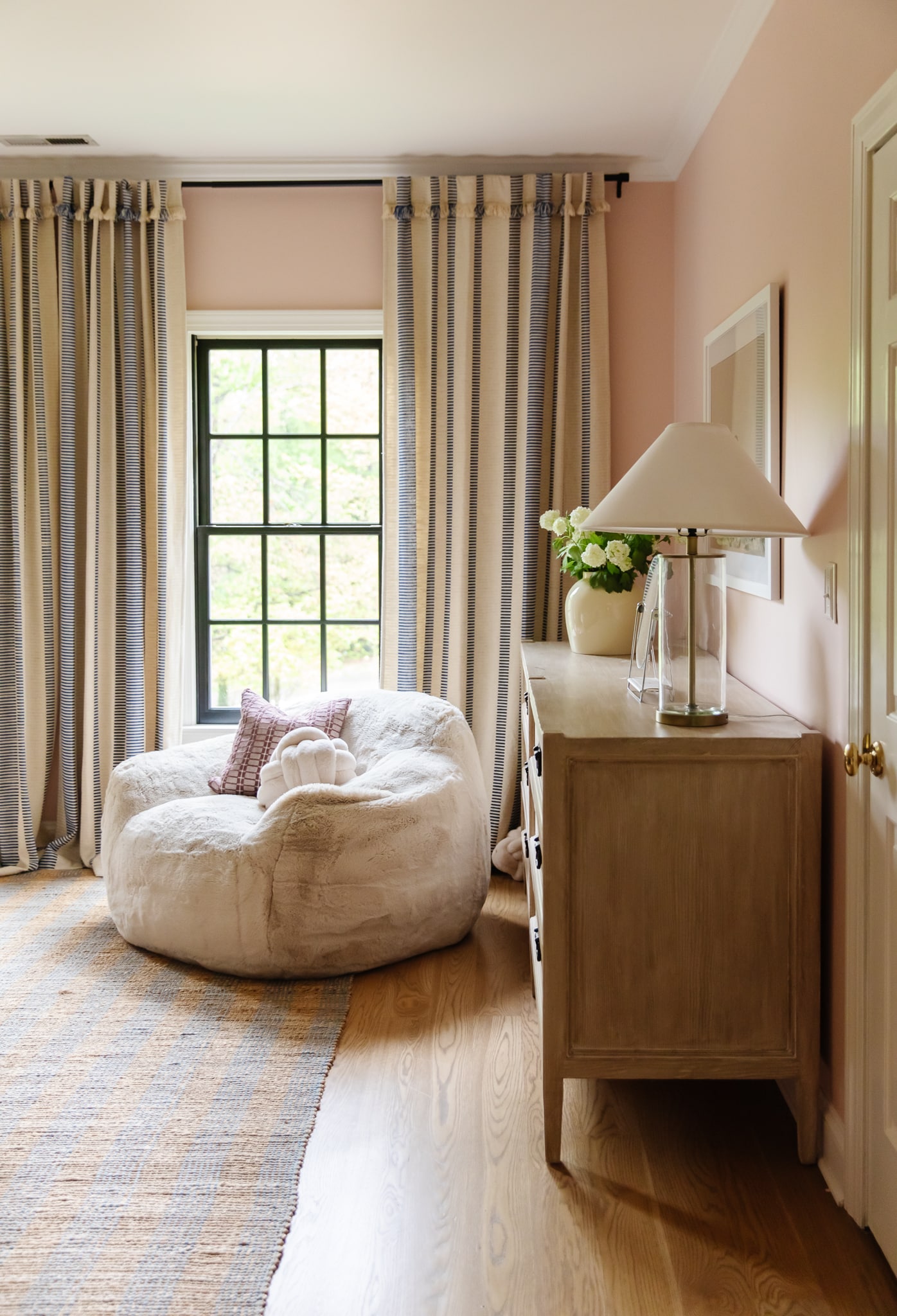 Chris Loves Julia | Greta's bedroom with pale pink paint and oversized plush velvet chair