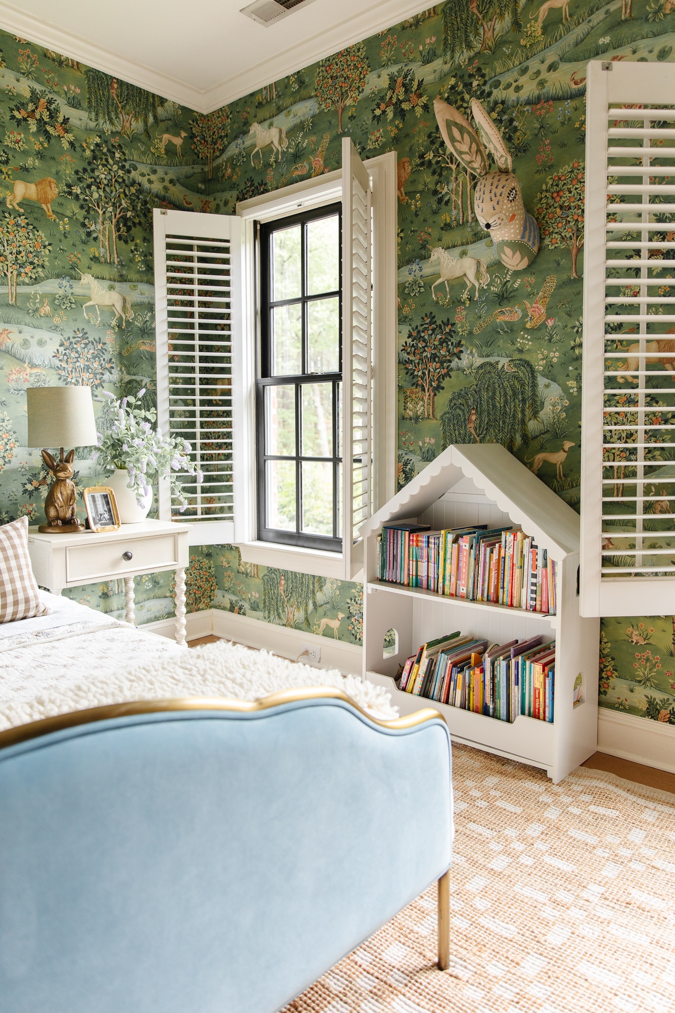 Chris Loves Julia | Polly's bedroom with dollhouse bookcase and whimsical green wallpaper
