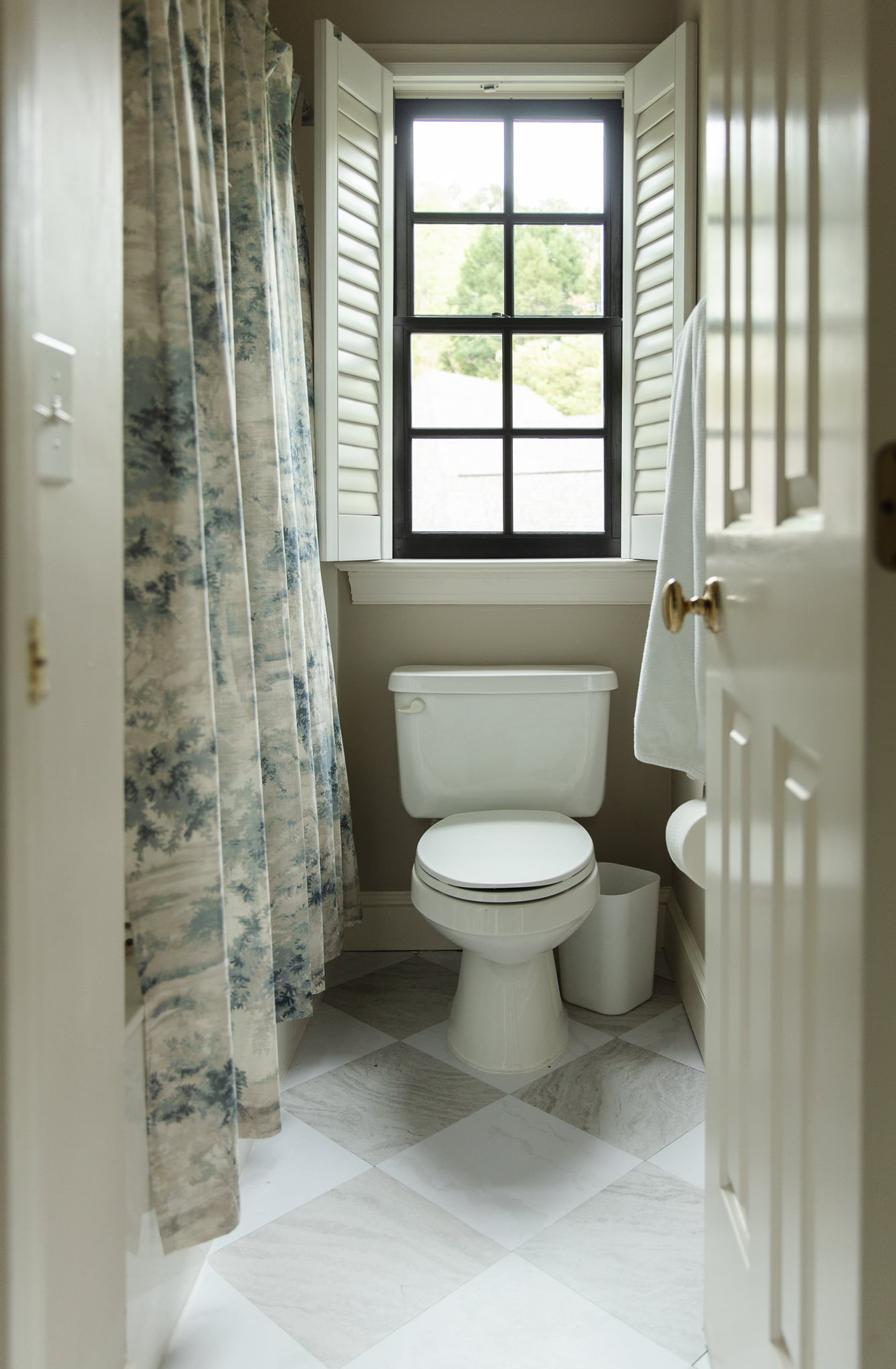 Chris Loves Julia | Jack & Jill bathroom with toile shower curtain and gray and white FloorPops
