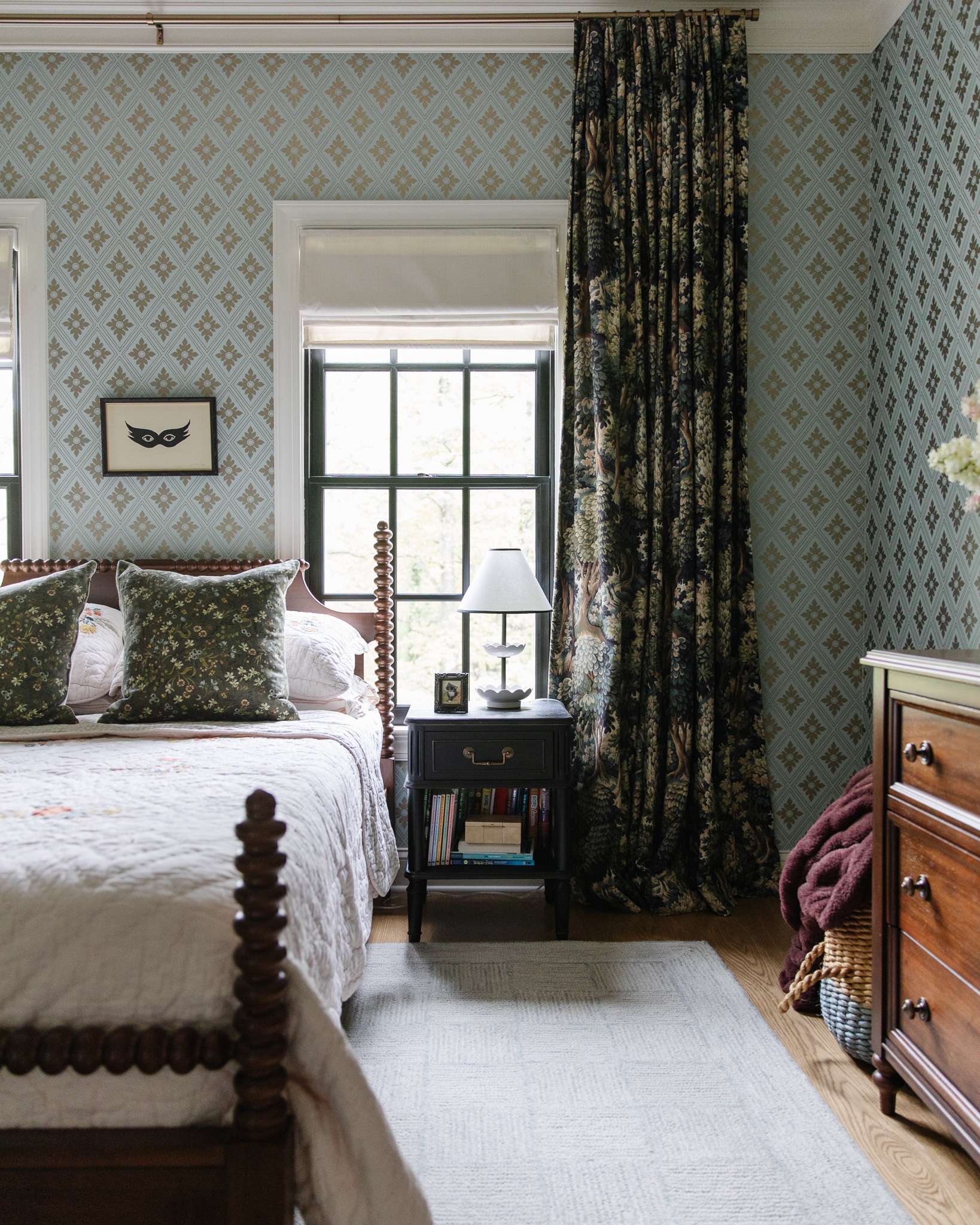 Chris Loves Julia | Faye's bedroom with teal blue wallpaper, woodland drapes and turned wood bed