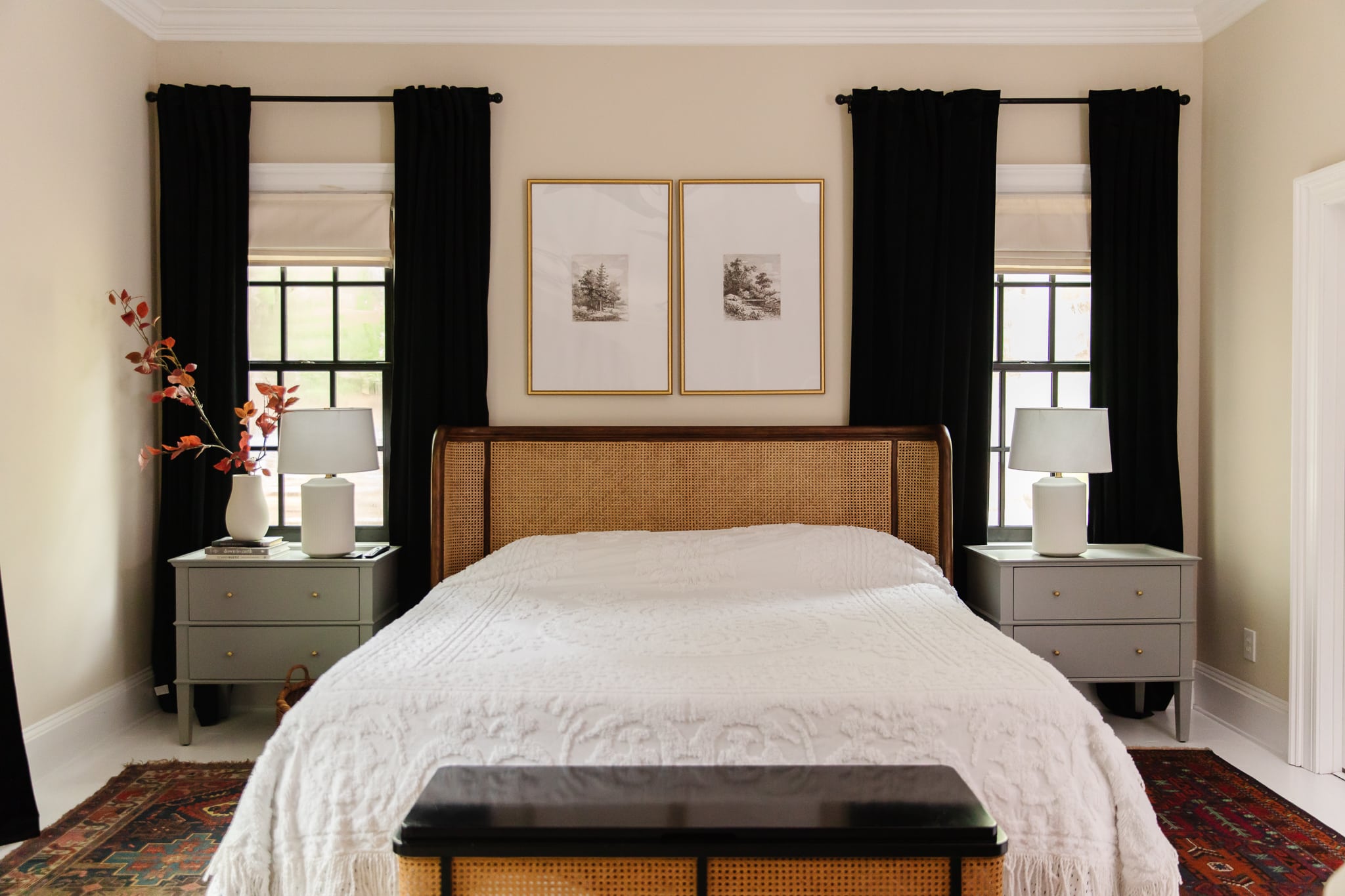 Chris Loves Julia | Guest house bed with white coverlet, black curtains and caned back headboard