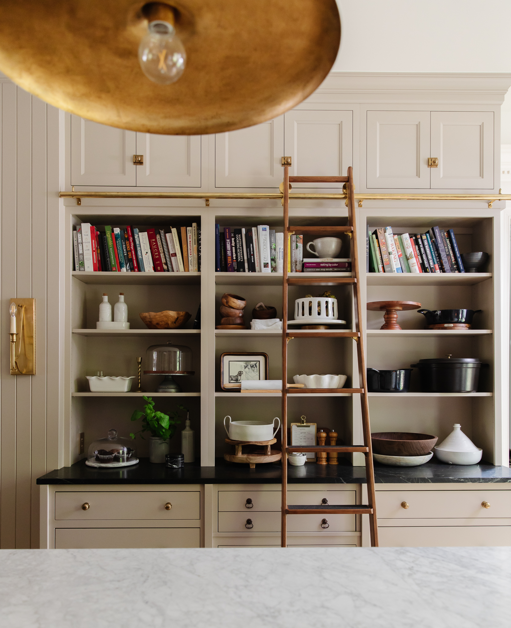 Chris Loves Julia | Kitchen with open cabinets and library ladder