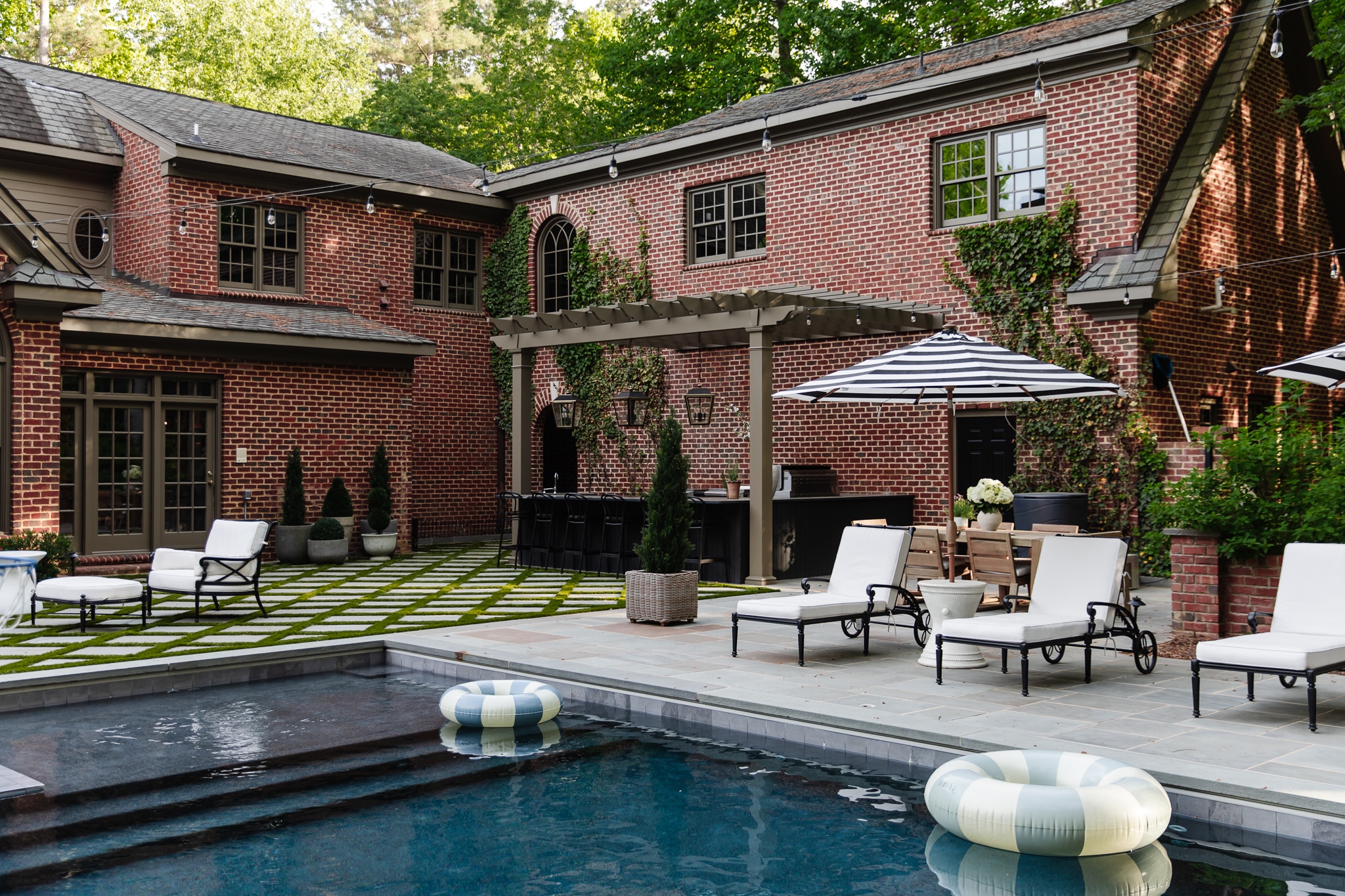 Chris Loves Julia | Modern Colonial Brick Home Backyard Exterior with Cromwell Gray Paint Trim and Pool 