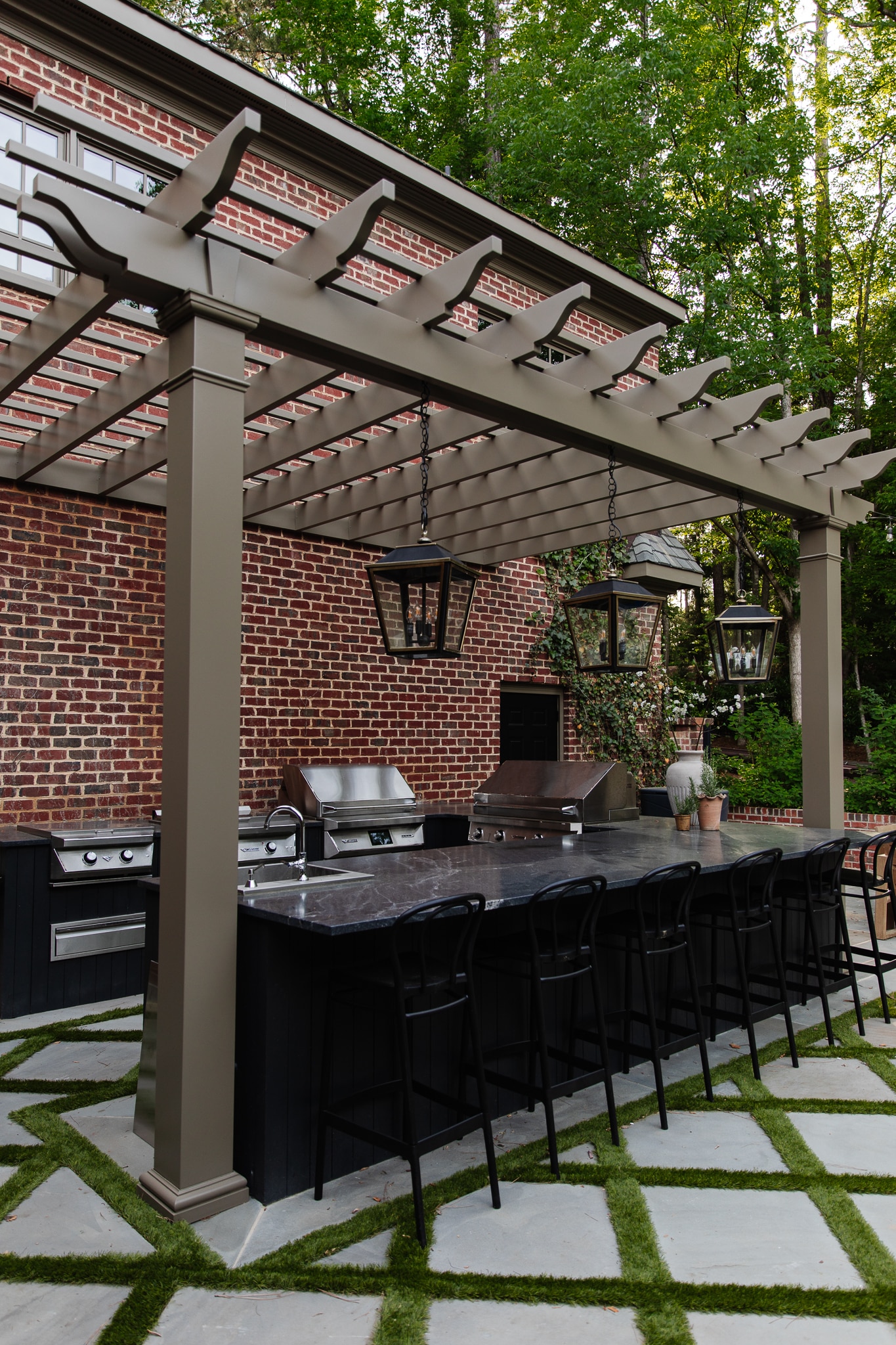 Chris Loves Julia | Outdoor Kitchen with Pergola Painted in Cromwell Gray, a Moody Brown Color