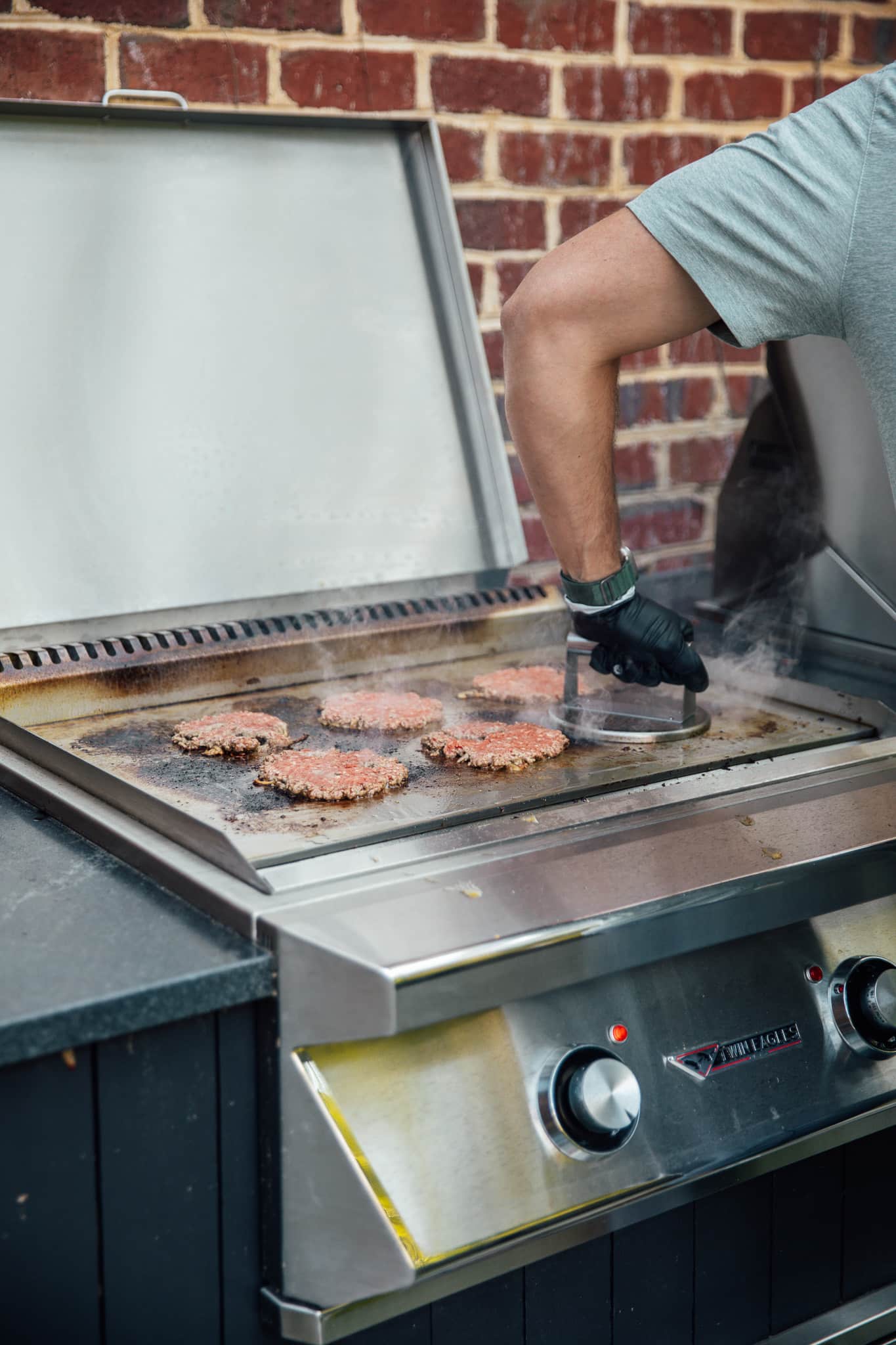 Chris Loves Julia | Outdoor kitchen with flat-top grill and smash burgers on top
