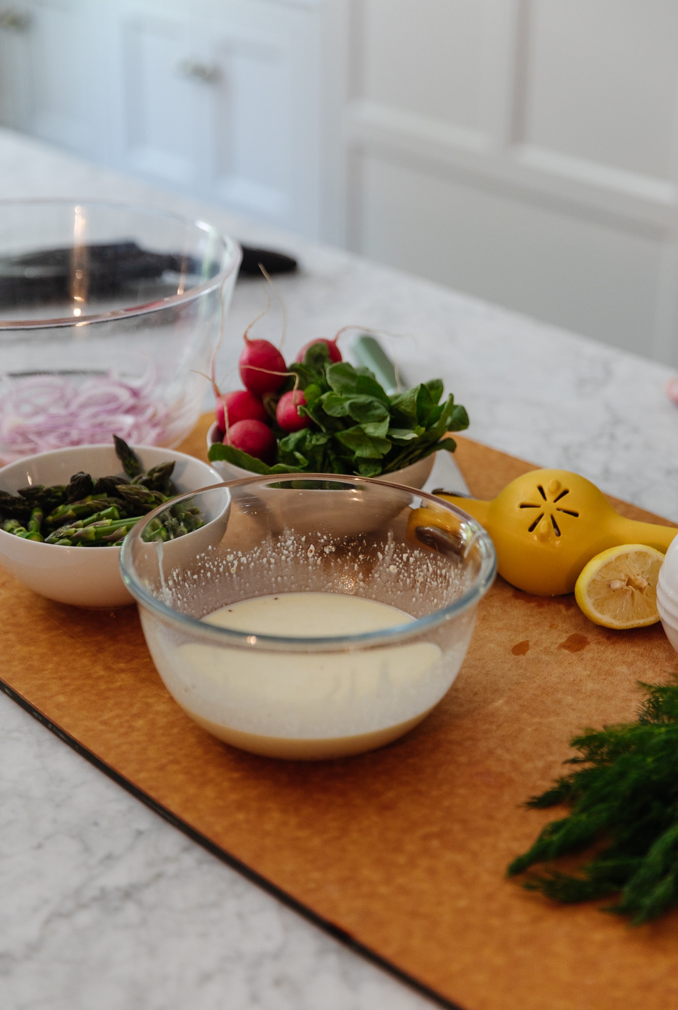 Chris Loves Julia | Ingredients to make classic potato salad with a twist, featuring dill, asparagus and radishes
