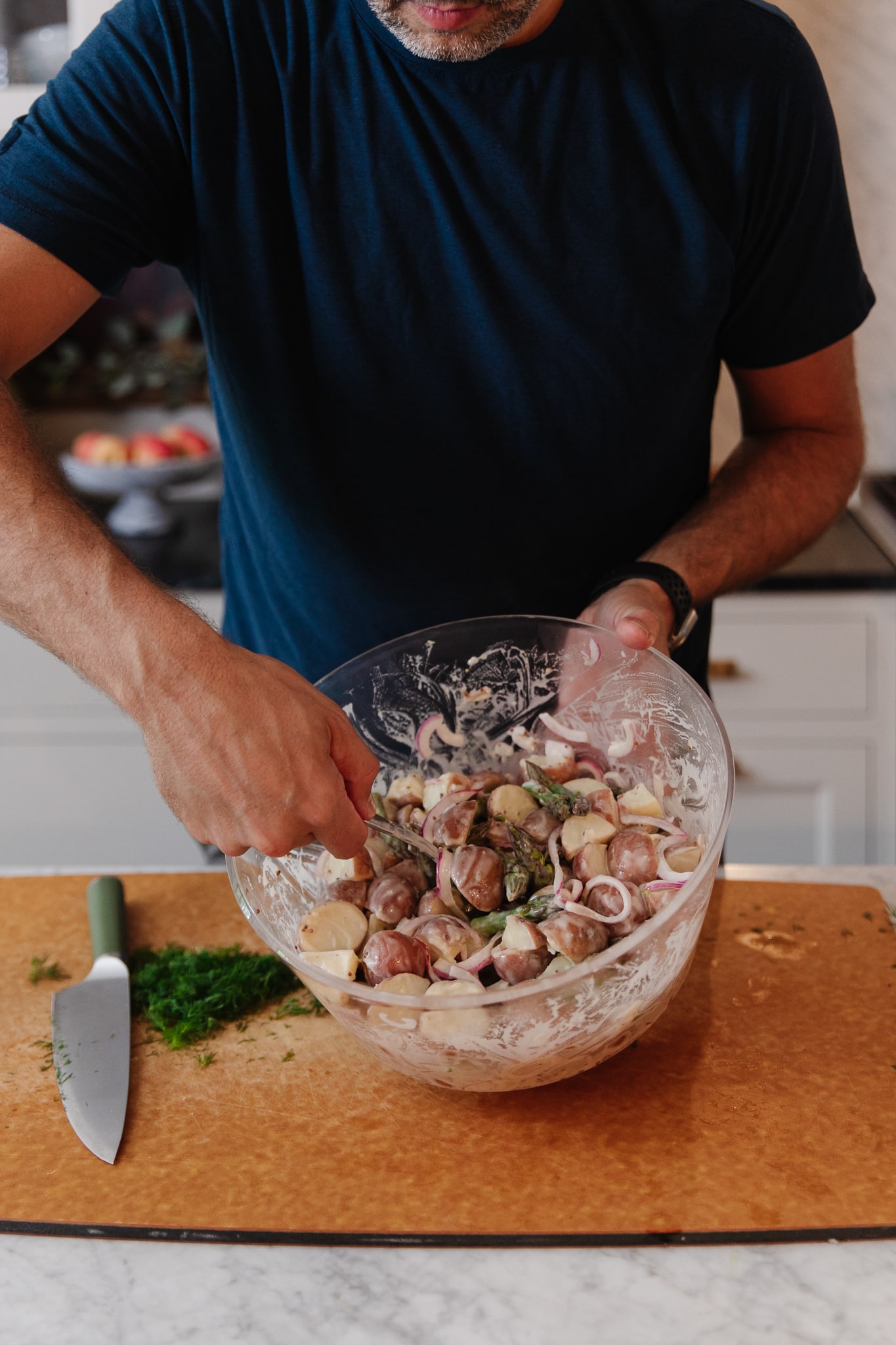 Chris Loves Julia | Chris mixing potato salad in a glass bowl