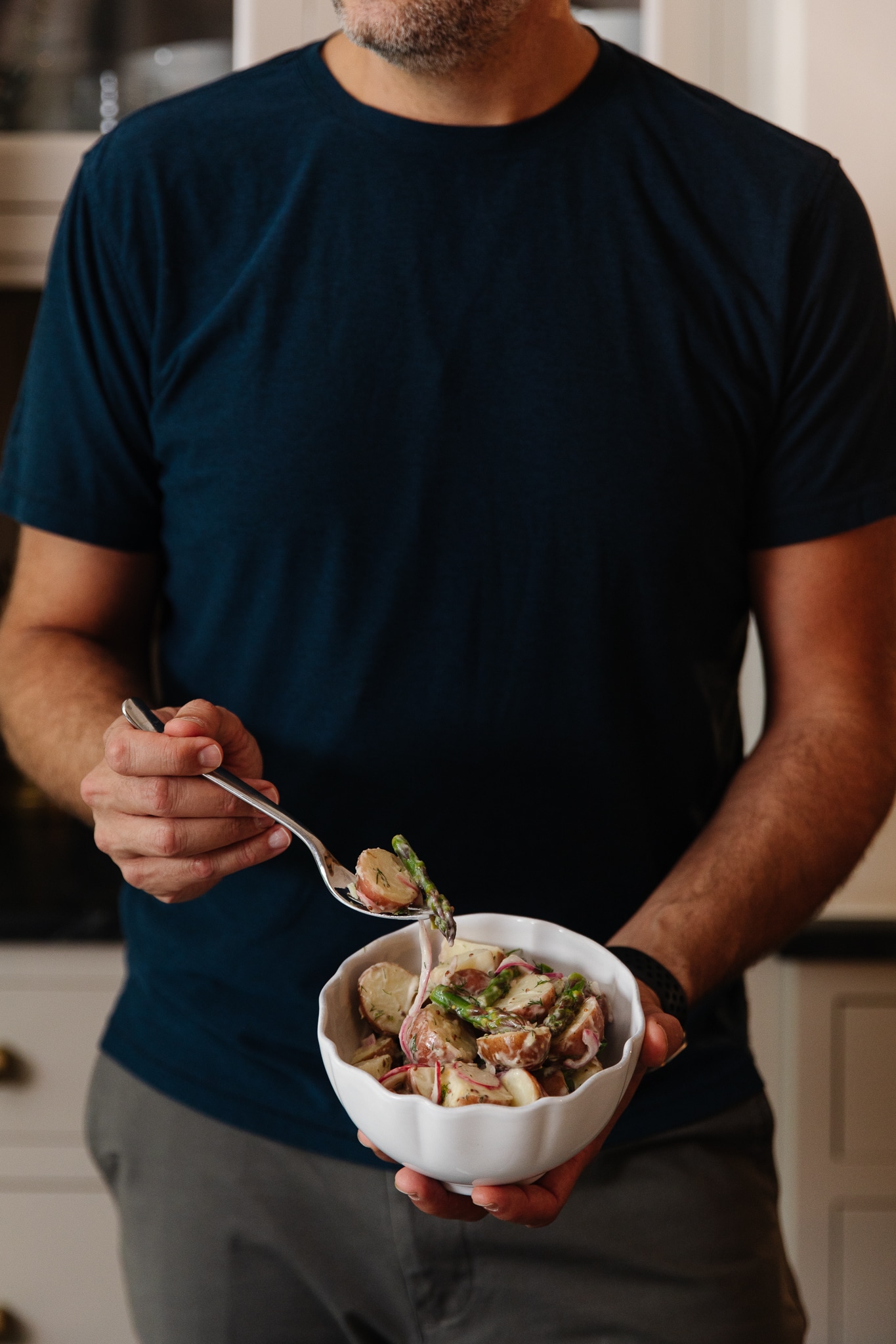 Chris Loves Julia | Chris with a bowl of classic potato salad with a twist, featuring dill, asparagus and radishes